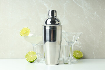 Shaker with fresh lime on a light background