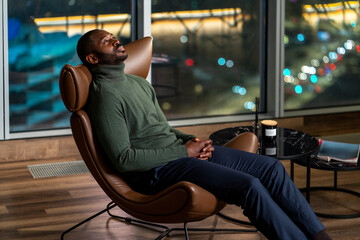 Man Relaxing in a Lounge Chair at Night