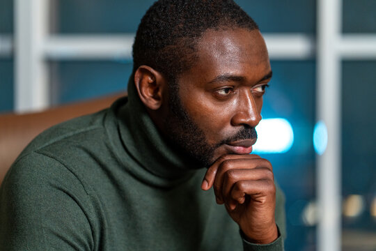 Thoughtful Man in Green Turtleneck