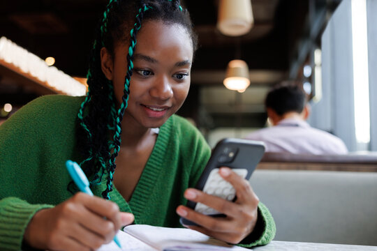 Girl studying distracted by video call 
