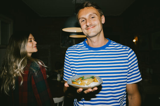 Man Proudly Presenting a Dish