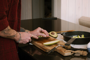 A man is focused on preparing fresh ingredients in his modern kitchen