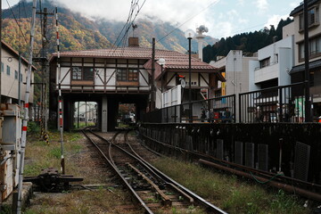 Scenic Onsen Station Built Over Tracks in a Rustic Mountain Town