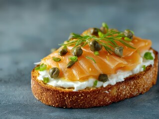 Savory open-faced sandwich with delicious smoked salmon, cream cheese, capers, and fresh herbs, offering an enticing and gourmet culinary experience for food lovers