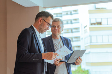 A two man businessman Reviewing Documents and Digital Tablet in Modern Office