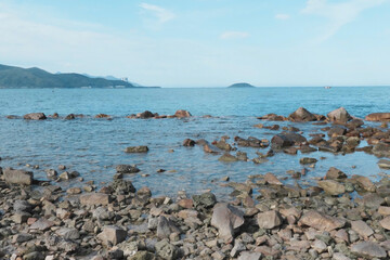 Close-up of natural white coral stones and a spiral seashell arranged on the beach, photographed at Hon Do (Red Island), Nha Trang, Vietnam, on June 1st. The image highlights the textures and organic 