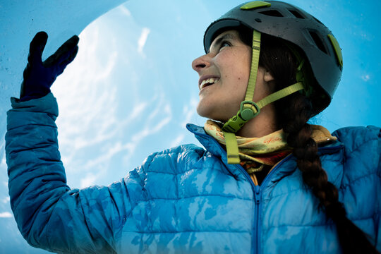 closeup of woman exploring an ice cavern in patagonia