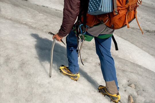 Adventurer Trekking Glacial Landscape with  technical Gear