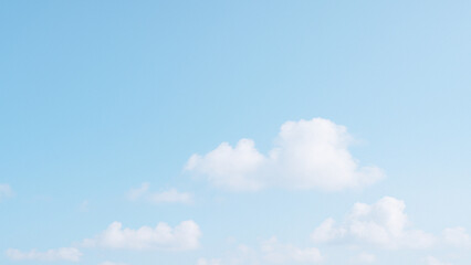 bright sky background with soft white clouds and pastel blue sky, peaceful, minimal and airy mood, copy space for text