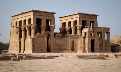 The temple of dendur with its distinctive architecture and sandstone construction in a desert landscape