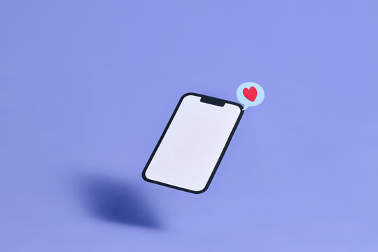 A modern frameless mobile phone floats above a violet surface