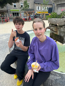 UGC of teens eating ice cream  in village square, France
