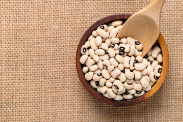 Black-eyed pea or cowpea in wooden bowl with scoop, Food ingredient, Top view