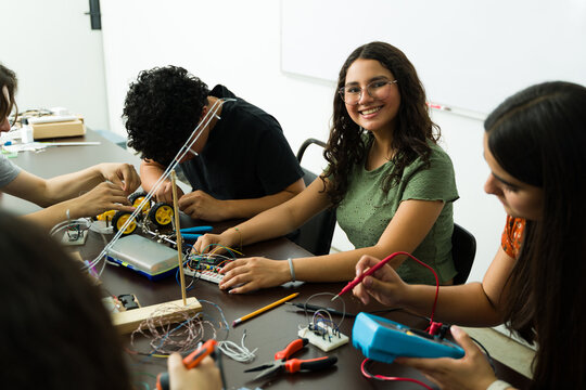 High school students building robot in electronics class