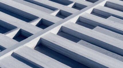 Naklejka premium Close-up view of a textured concrete surface with geometric patterns and shadows