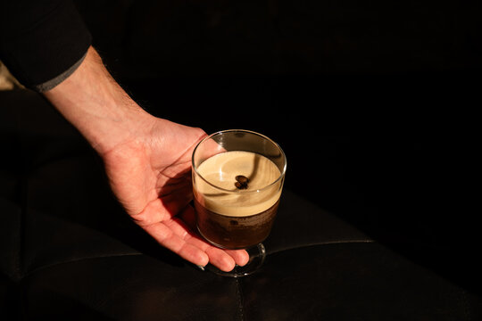 Person holding espresso martini
