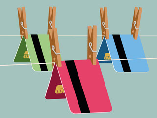 Colorful bank cards clipped with pins on string