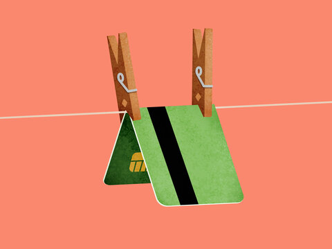 Green bank card clipped with clothespin