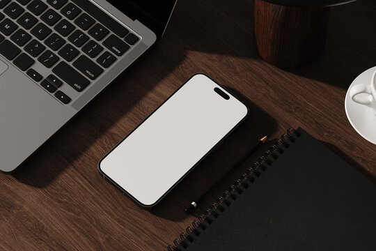 Smartphone with blank screen on wooden desk in modern workspace