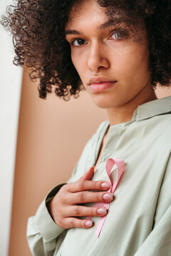 Embracing Hope With a Pink Ribbon in Soft Light