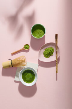 Top view green tea matcha set on pastel pink background