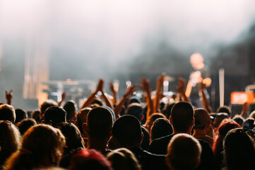 Anonymous crowd at a concert. People enjoying live music. Music stage.
