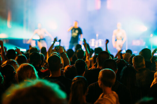 Anonymous crowd at a concert. People enjoying live music. Music stage.