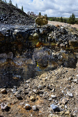 Rockhounding in Central Oregon, thunderegg digging pit with miner’s pick, recreational hobby digging for pretty rocks
