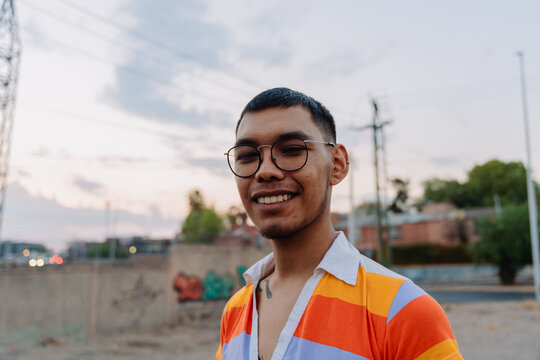 Wide angle portrait of an smiling man in colorful clothes.
