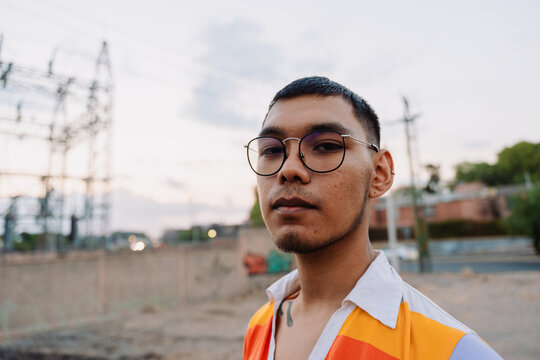 Non binary man looking at camera with tenderness.