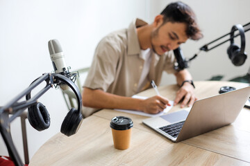 Radio Host Writing Down Questions Before Start The Engaging Conversation with Guest