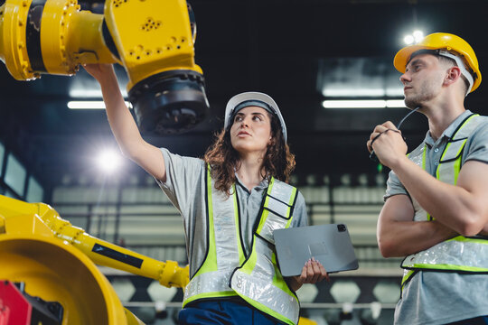 professional technician engineer with safety helmet hard hat working in industrial manufacturing factory, men at work to checking equipment of machinery production technology or construction operating