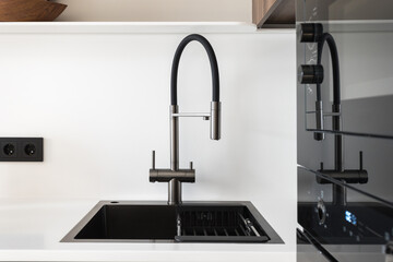 kitchen faucet on a stylish metal sink