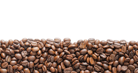 Many roasted coffee beans on white background. Coffee beans border with area for copy space. Close up images.