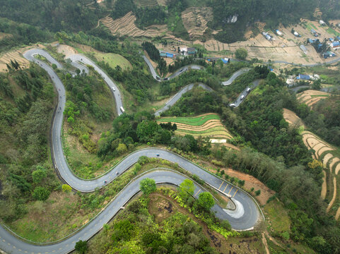 Winding mountain roads through lush green terraced fields