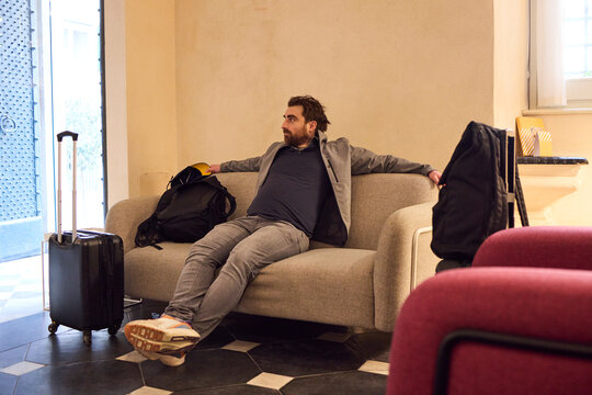Young man spending time in a hotel lobby