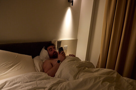 Man laying in a hotel bed