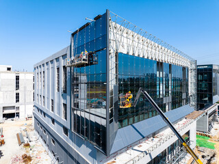Construction Workers Installing Glass Windows on a Building