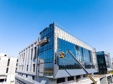 Construction Workers Installing Glass Windows on a Building