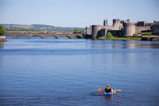 kayaker on the River Shannon in Limerick, Ireland with view of King John's castle