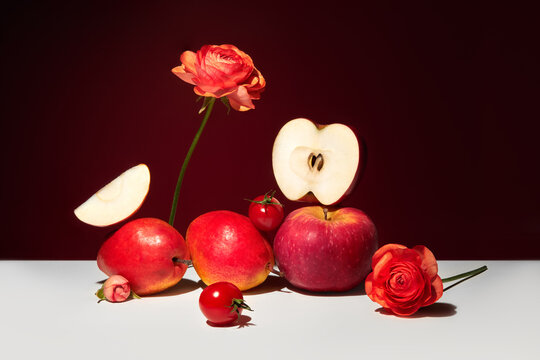 Abstract still life with apples, pears, cherry tomatoes and flowers