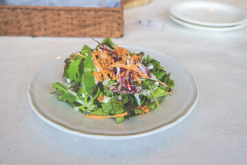 Salad with Mixed Greens and Dressing on White Plate