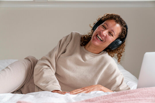headphones laughing laptop