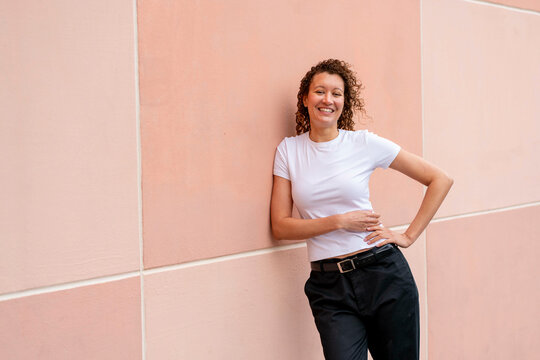 happy portrait against pink wall