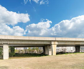 Obraz premium Looking up at a Large Interstate Highway Overpass and Blue Sky