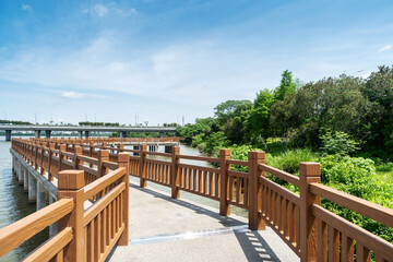 Wooden bridge over little river in city park