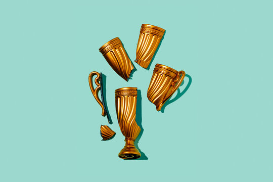 broken gold cup on a green background