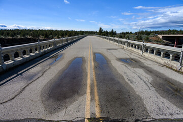 View from center of old highway over historic crooked river gorge bridge in central Oregon, scenic day for spring travel

