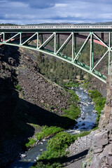 View of the steel arch of the old highway over historic crooked river gorge bridge in central Oregon, scenic day for spring travel
