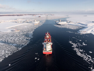 Container ship in ice covered sea, drone shot
